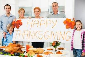 Large cheerful family celebrating Thanksgiving day. They are holding a big white paper saying Happy Thanksgiving. [url=https://www.istockphoto.com/search/lightbox/9786778][img]https://dl.dropbox.com/u/40117171/family.jpg[/img][/url]